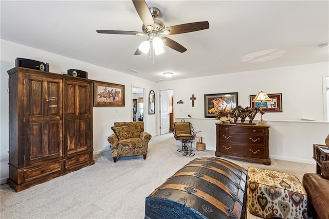 sitting room featuring light carpet, ceiling fan, and baseboards