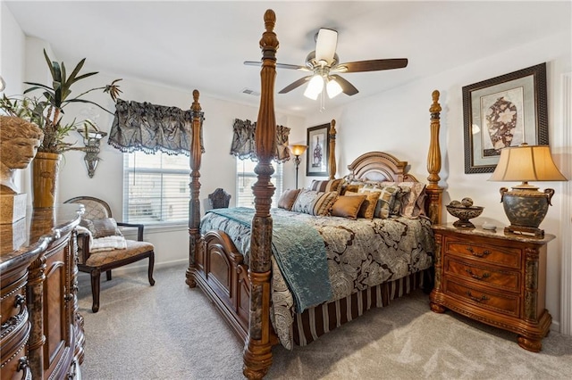 bedroom featuring light carpet, visible vents, and a ceiling fan