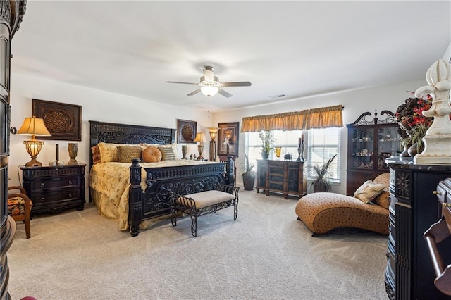 bedroom with light carpet, ceiling fan, and visible vents