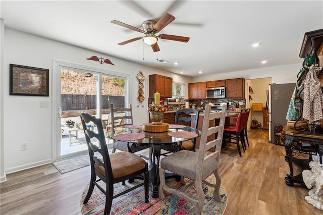 dining room featuring light wood-style floors, baseboards, visible vents, and recessed lighting