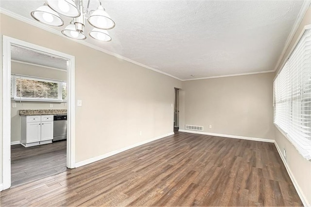 unfurnished room with crown molding, a textured ceiling, visible vents, and dark wood-style flooring