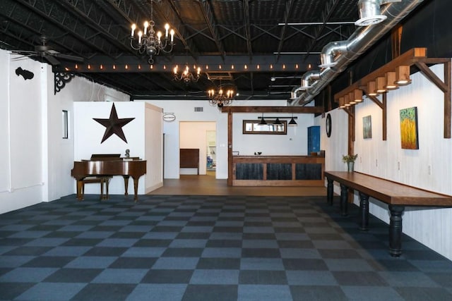 interior space featuring ceiling fan with notable chandelier