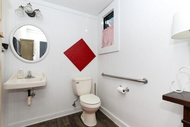 bathroom with toilet, sink, and hardwood / wood-style flooring