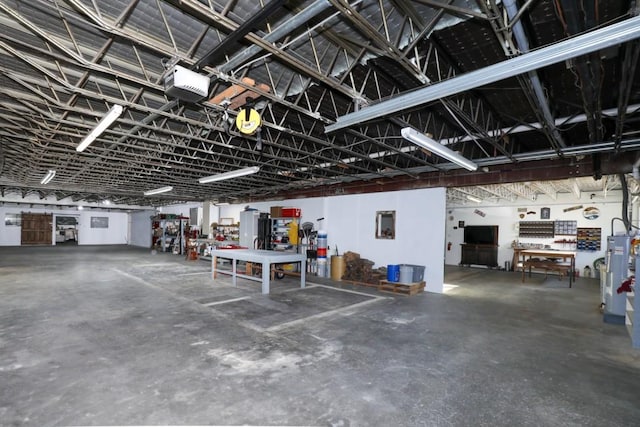 garage with a garage door opener and electric water heater