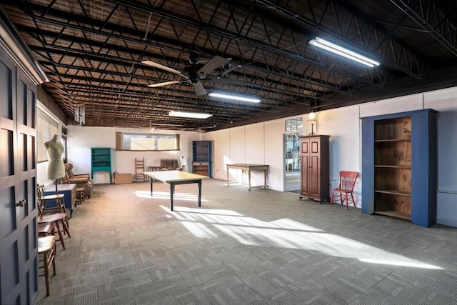 basement featuring carpet floors and ceiling fan