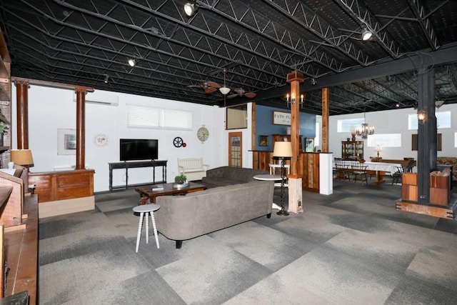 living room featuring a notable chandelier and a wall mounted air conditioner