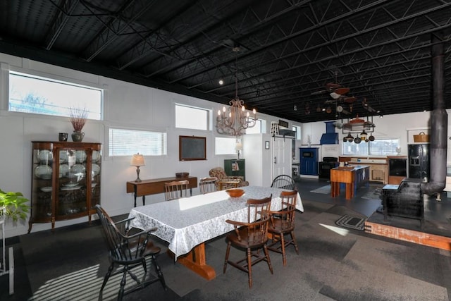 dining area featuring a high ceiling and a notable chandelier