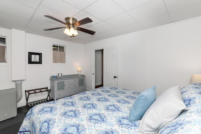 bedroom featuring a drop ceiling and ceiling fan