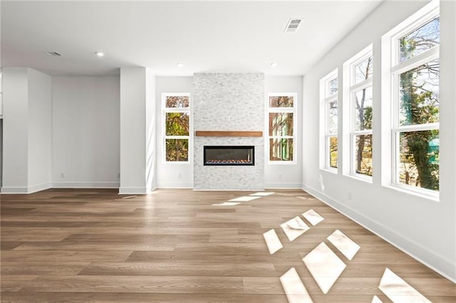 490 Hammons Way, Atlanta, GA 30315 - unfurnished living room featuring a fireplace, plenty of natural light, light wood-style flooring, and recessed lighting