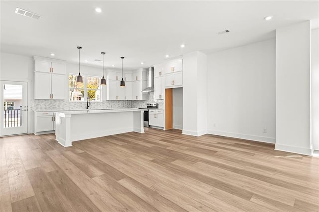 490 Hammons Way, Atlanta, GA 30315 - kitchen featuring electric range, wall chimney range hood, light wood-style flooring, white cabinetry, and tasteful backsplash