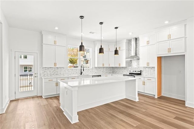 490 Hammons Way, Atlanta, GA 30315 - kitchen with wall chimney exhaust hood, range with electric cooktop, light wood-style floors, white cabinets, and recessed lighting