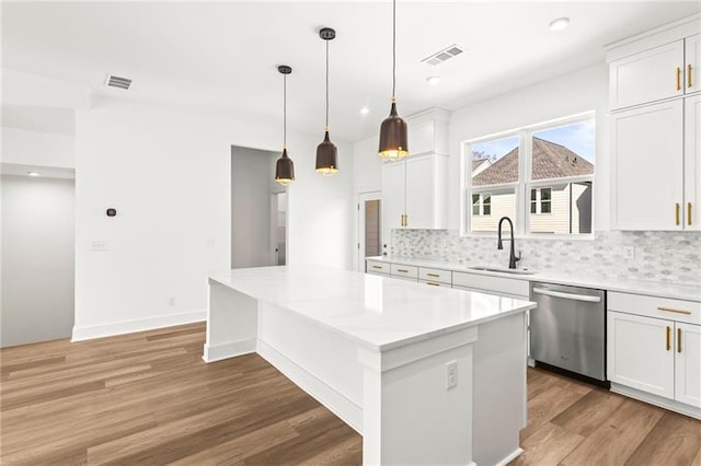490 Hammons Way, Atlanta, GA 30315 - kitchen with dishwasher, tasteful backsplash, a kitchen island, light wood finished floors, and white cabinetry
