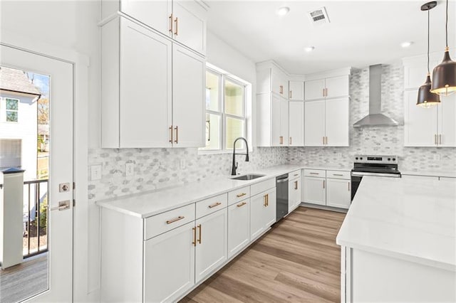 490 Hammons Way, Atlanta, GA 30315 - kitchen featuring stainless steel appliances, wall chimney exhaust hood, healthy amount of natural light, light countertops, and recessed lighting