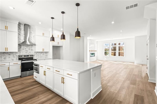 490 Hammons Way, Atlanta, GA 30315 - kitchen featuring wall chimney range hood, stainless steel range with electric stovetop, white cabinets, decorative backsplash, and recessed lighting