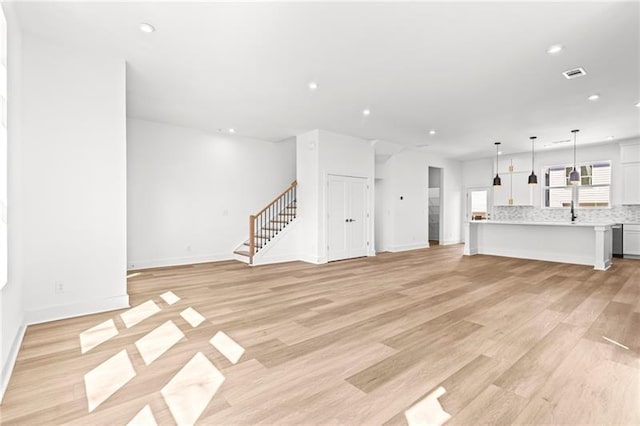 490 Hammons Way, Atlanta, GA 30315 - unfurnished living room featuring stairs, light wood-type flooring, and recessed lighting