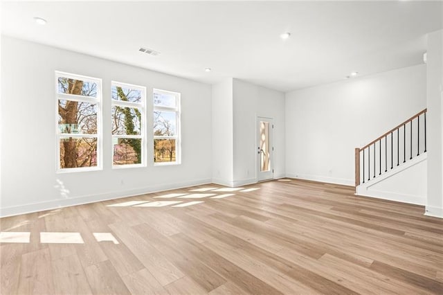490 Hammons Way, Atlanta, GA 30315 - unfurnished living room with light wood-style flooring, stairway, and recessed lighting