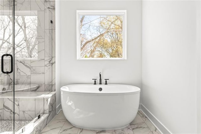 490 Hammons Way, Atlanta, GA 30315 - full bathroom featuring marble look tiles, a freestanding tub, and a marble finish shower