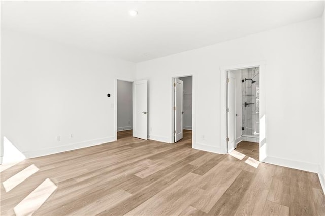 490 Hammons Way, Atlanta, GA 30315 - unfurnished bedroom featuring light wood-type flooring, a spacious closet, a closet, and connected bathroom
