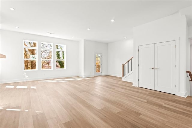 490 Hammons Way, Atlanta, GA 30315 - unfurnished living room featuring light wood finished floors, recessed lighting, and stairway