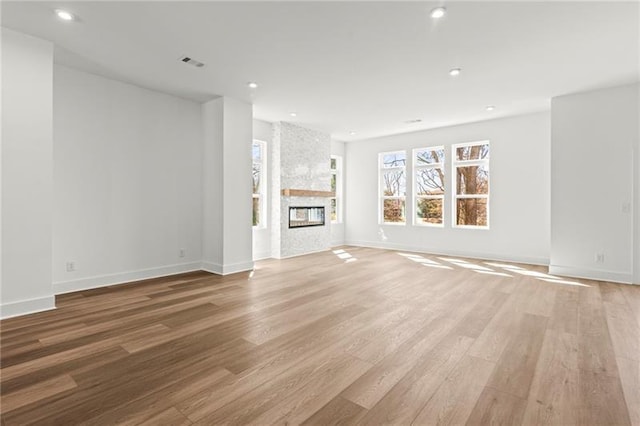 490 Hammons Way, Atlanta, GA 30315 - unfurnished living room with light wood finished floors, a stone fireplace, and recessed lighting