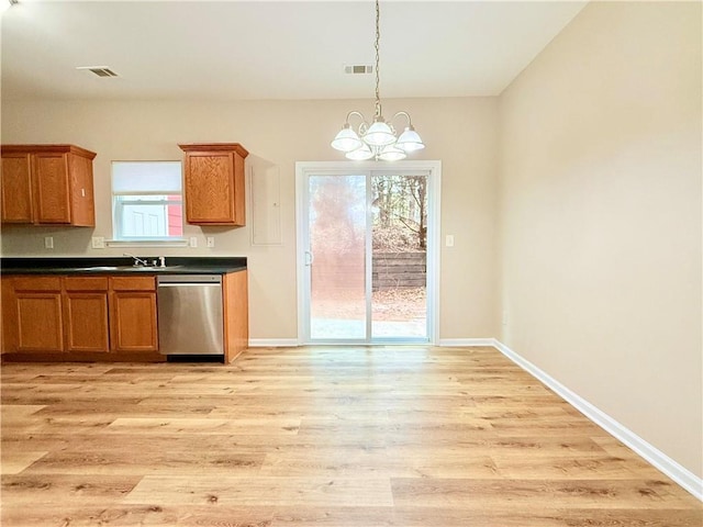 kitchen featuring a healthy amount of sunlight, a chandelier, stainless steel dishwasher, and light wood-type flooring