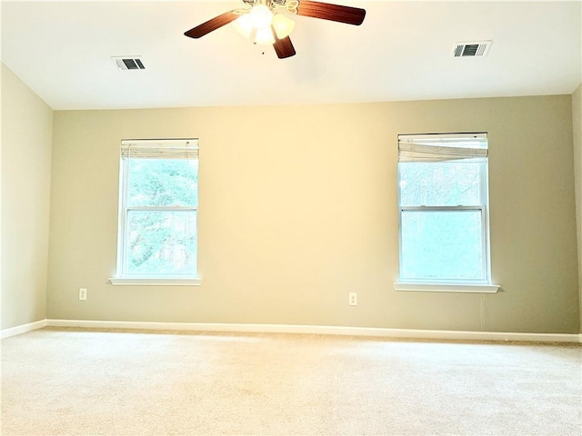 carpeted spare room featuring ceiling fan