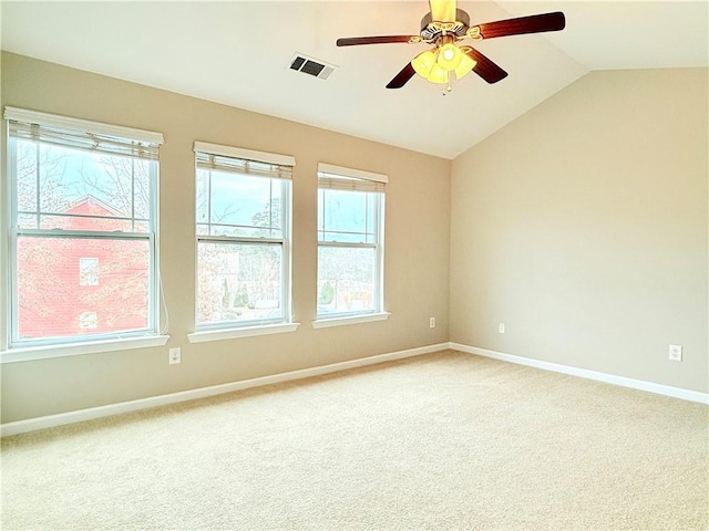 carpeted empty room featuring ceiling fan and vaulted ceiling