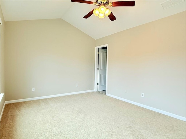 carpeted spare room with ceiling fan and vaulted ceiling