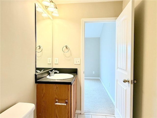 bathroom with tile patterned flooring, vanity, and toilet