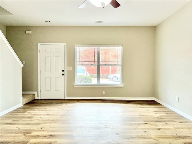 foyer entrance with ceiling fan and light hardwood / wood-style flooring