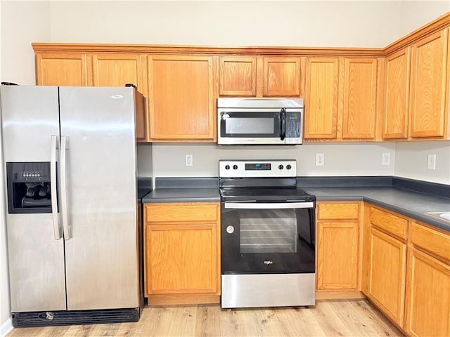 kitchen featuring appliances with stainless steel finishes and light wood-type flooring