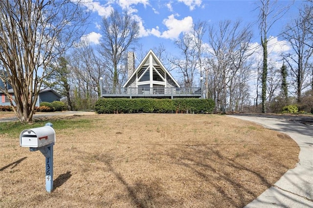 view of front of home with a chimney and a front yard