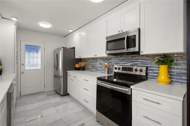 kitchen with white cabinetry, appliances with stainless steel finishes, light countertops, and decorative backsplash