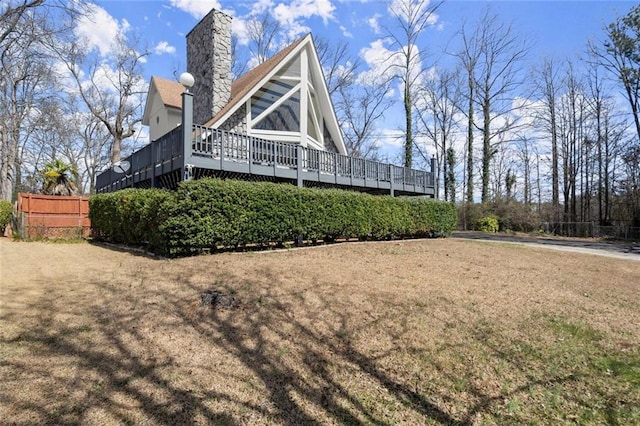 exterior space featuring a chimney and a wooden deck