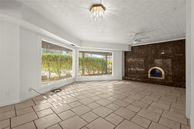 unfurnished living room with a fireplace, a textured ceiling, baseboards, and ceiling fan