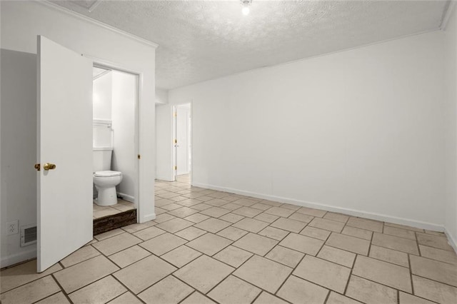 bathroom with toilet, baseboards, visible vents, and a textured ceiling