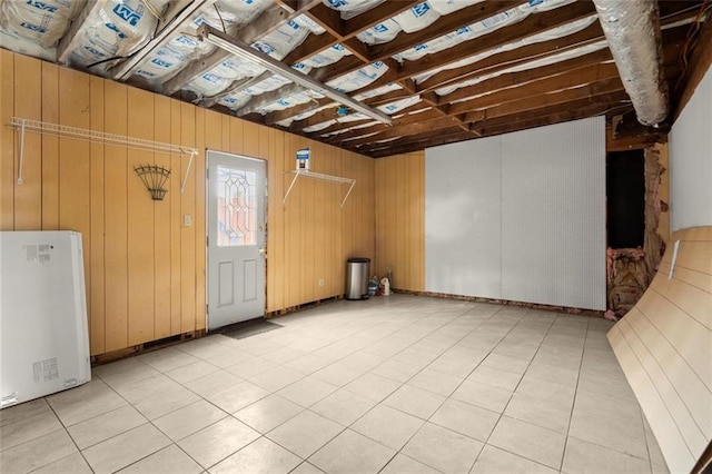 interior space featuring tile patterned flooring and freestanding refrigerator