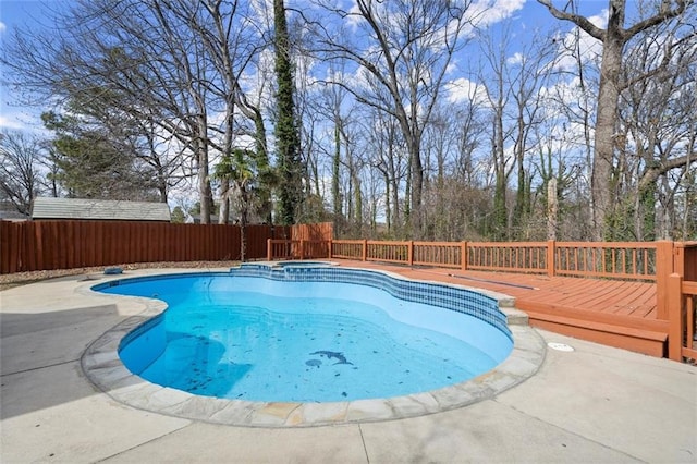 view of swimming pool featuring a fenced backyard, a pool with connected hot tub, and a wooden deck