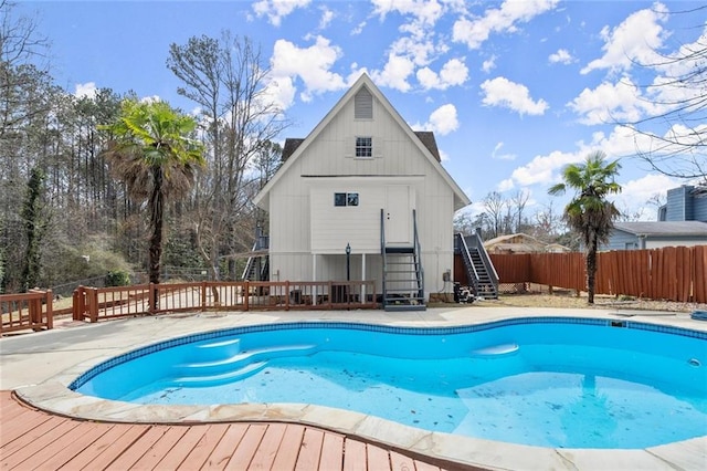 view of swimming pool with a fenced in pool, fence, and a deck