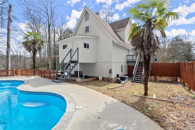 view of pool with a fenced backyard, stairs, a fenced in pool, and a wooden deck