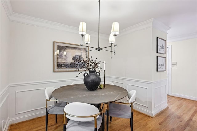 1634 Ponce De Leon Ave NE Unit 514, Atlanta, GA 30307 - dining room featuring crown molding, wood finished floors, a decorative wall, a wainscoted wall, and a chandelier