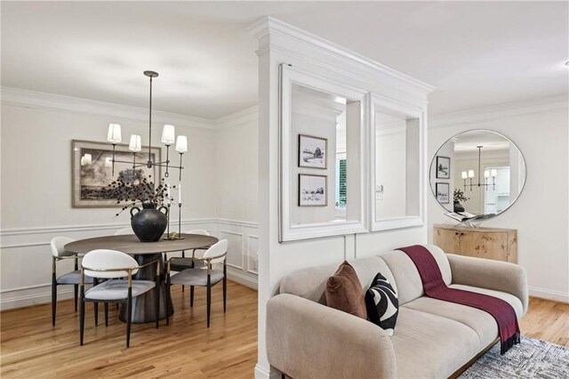 1634 Ponce De Leon Ave NE Unit 514, Atlanta, GA 30307 - living area with a chandelier, light wood-type flooring, ornamental molding, a wainscoted wall, and a decorative wall