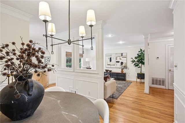 1634 Ponce De Leon Ave NE Unit 514, Atlanta, GA 30307 - dining room with light wood finished floors, crown molding, recessed lighting, and ornate columns