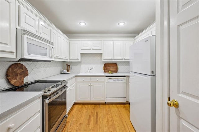 1634 Ponce De Leon Ave NE Unit 514, Atlanta, GA 30307 - kitchen with white appliances, light countertops, white cabinetry, and recessed lighting