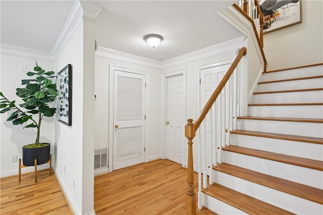 1634 Ponce De Leon Ave NE Unit 514, Atlanta, GA 30307 - entrance foyer with light wood finished floors, stairway, and ornamental molding