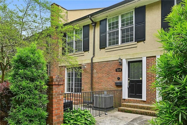 1634 Ponce De Leon Ave NE Unit 514, Atlanta, GA 30307 - doorway to property featuring stucco siding and brick siding