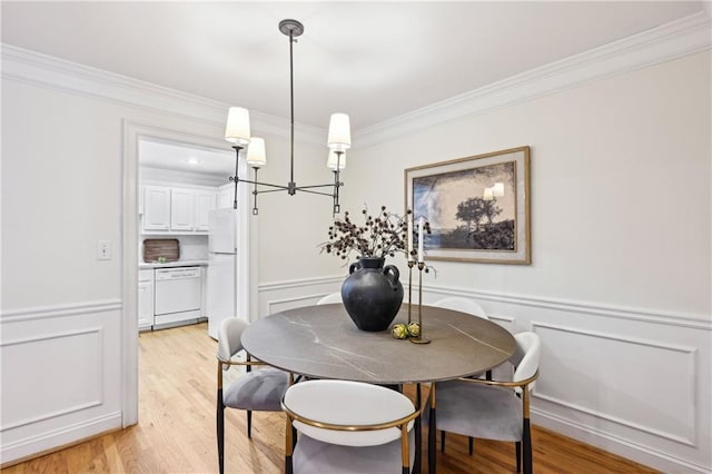 1634 Ponce De Leon Ave NE Unit 514, Atlanta, GA 30307 - dining room featuring ornamental molding, a decorative wall, light wood-style flooring, and wainscoting