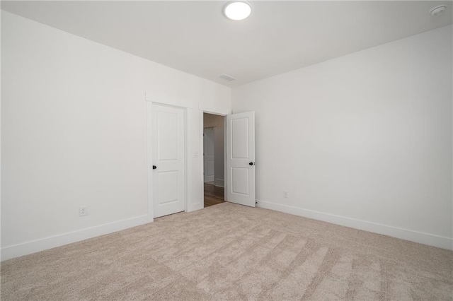spare room with carpet floors and baseboards