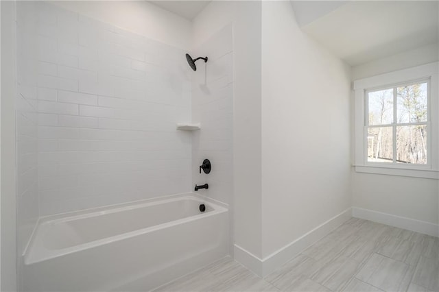 bathroom featuring  shower combination and baseboards