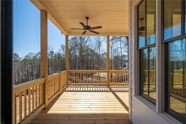 wooden terrace featuring a ceiling fan